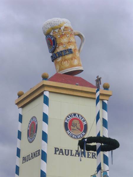 Paulaner tower at Munich Oktoberfest topped by giant beer mug