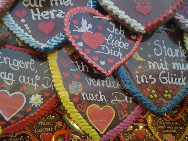 Gingerbread heart cookies decorated with colorful icing messages