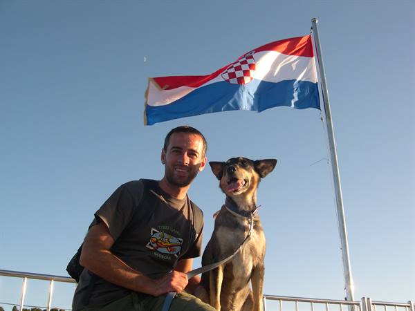 LUCKY POSING FOR THE RITUAL PHOTO WITH THE FLAG