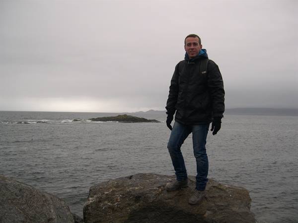 IN THE BACKGROUND, AMONG THE CLOUDS, THE ISLE OF SKYE