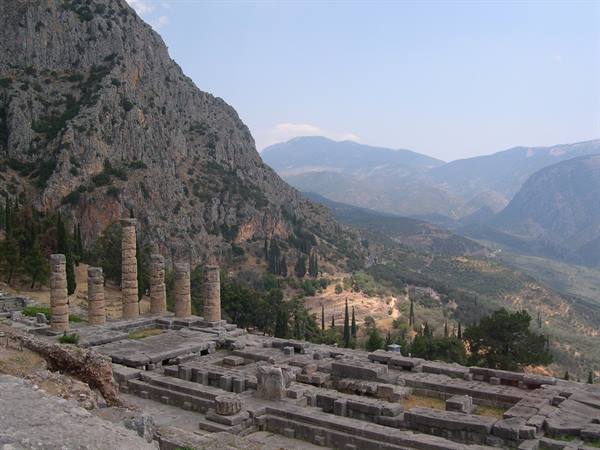 THE ANCIENT RUINS OF DELPHI PERCHED ON THE MOUNTAINSIDE 