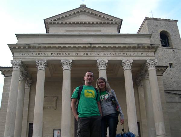 Couple in front of San Marino Basilica among pale stone columns