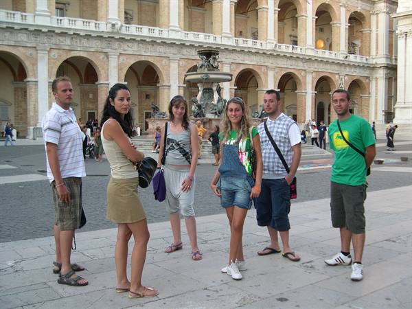 Six young people posing in front of the Madonna fountain in Loreto