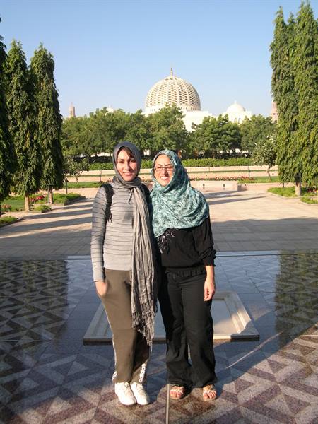 WITH HEAD COVERED, AS TRADITION REQUIRES, TO VISIT THE MOSQUE OF MUSCAT