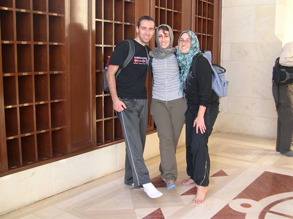 CHANGING SHOES AT THE MOSQUE ENTRANCE