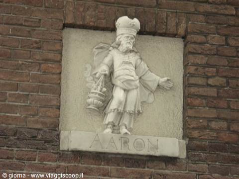 Stone relief of high priest Aaron with censer, set into red brick wall