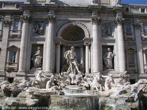 Trevi Fountain in Rome, marble statues and flowing water in sunlight