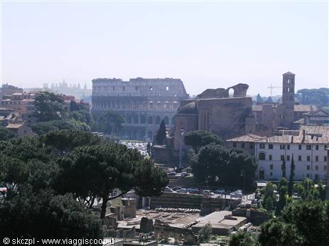 The Colosseum among pines and Roman Forum ruins