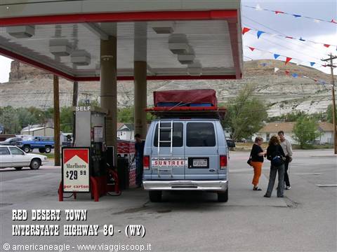Converted camper van refueling at old gas station in East Echo, Wyoming