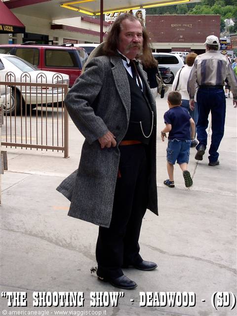Actor in grey coat with mustache on Deadwood street