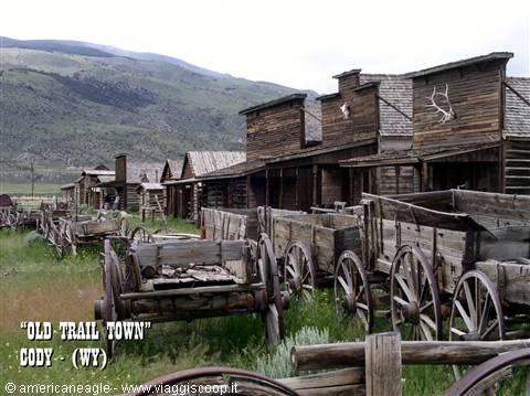 Antique wooden wagons among log buildings at Old Trail Town, Cody