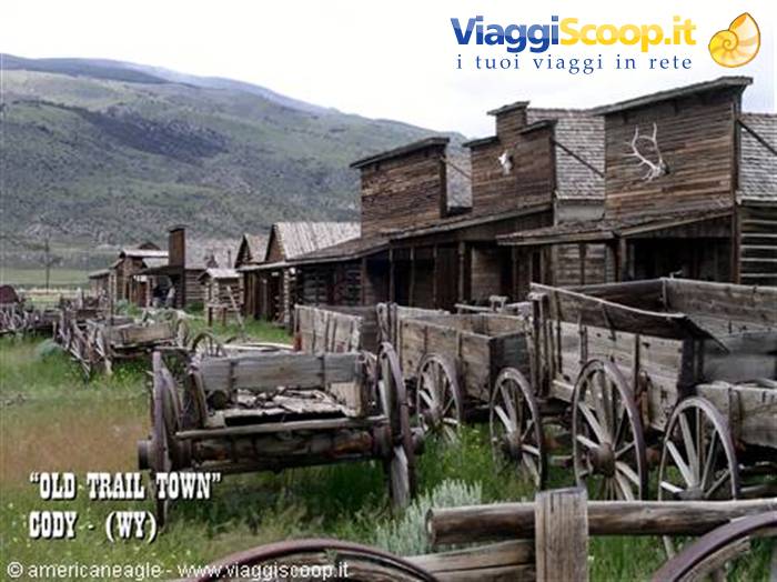 Antique wooden wagons among log buildings at Old Trail Town, Cody