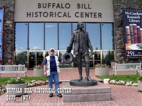 Tourist beside the bronze statue outside the Buffalo Bill Historical Center, Cody