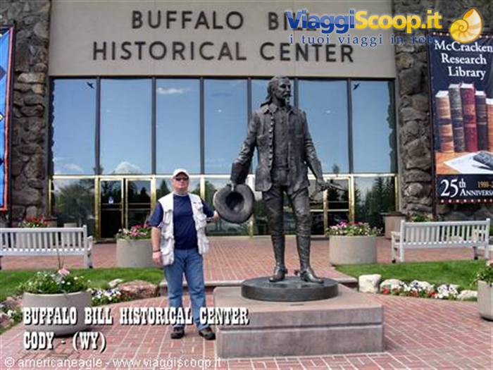Tourist beside the bronze statue outside the Buffalo Bill Historical Center, Cody