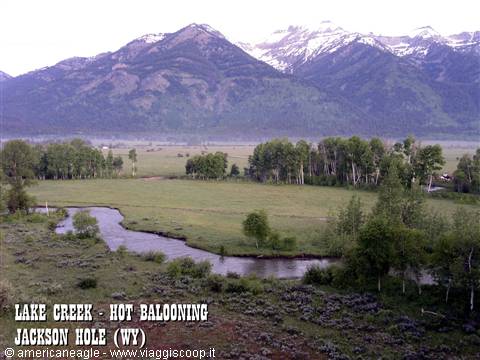 Lake Creek river winding through green meadows, snowy mountains, Jackson Hole