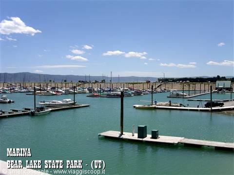 Bear Lake State Park marina: boats moored at wooden docks, turquoise water, distant mountains