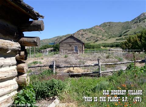 Log cabins at Old Deseret Village, wooden fences and green hills