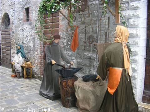 Nativity scene with blacksmith mannequins working in a stone alley