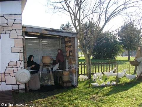 Farmer statues at work in wooden shed with geese and sheep