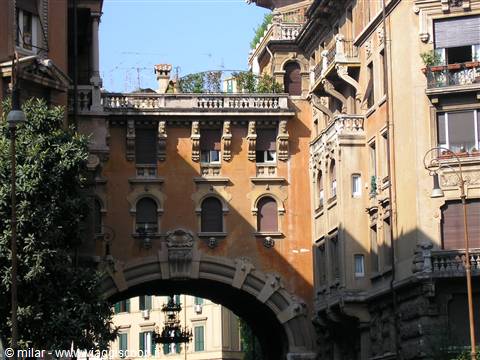 Brick arch between ornate buildings, Quartiere Coppedè, Rome