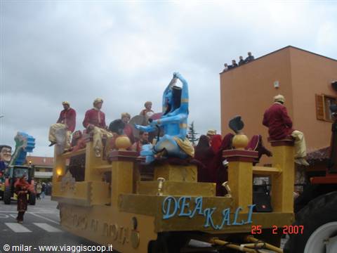 Carnival float with blue statue of goddess Kali and costumed people