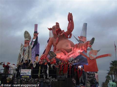 Viareggio carnival float with giant paper-mâché pig and masked performers