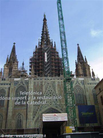 Barcelona Cathedral gothic spire under scaffolding with a green crane