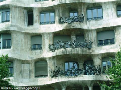 Wavy stone facade of La Pedrera in Barcelona, with wrought-iron balconies