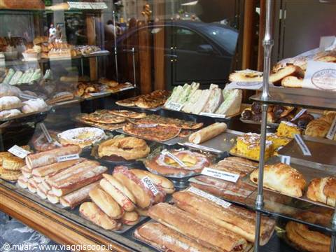 Bakery shop window filled with sandwiches, pizza, focaccia and pastries