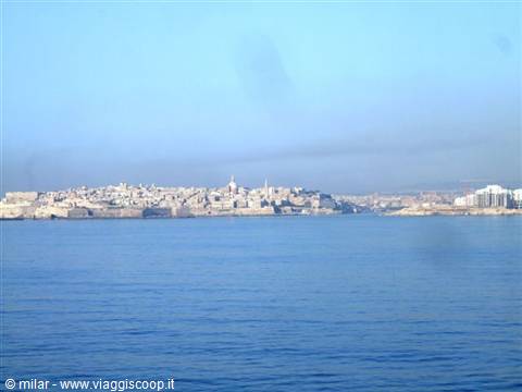 The fortified city of Valletta seen from the sea under a blue sky