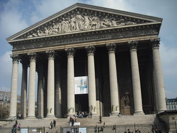 La Madeleine church in Paris, Corinthian columns, sculpted pediment, tourists on steps