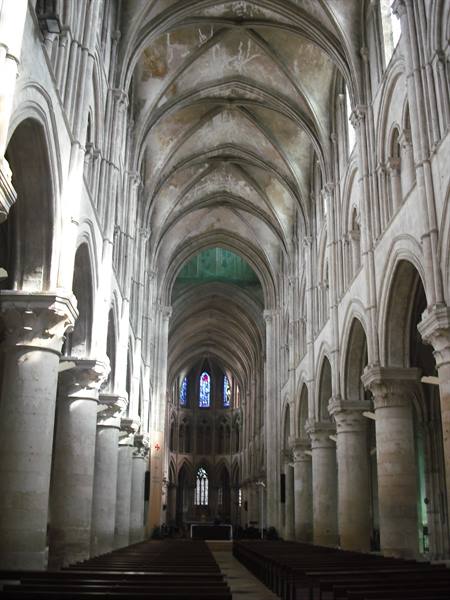Gothic nave with stone pillars, ribbed vaults and stained glass windows