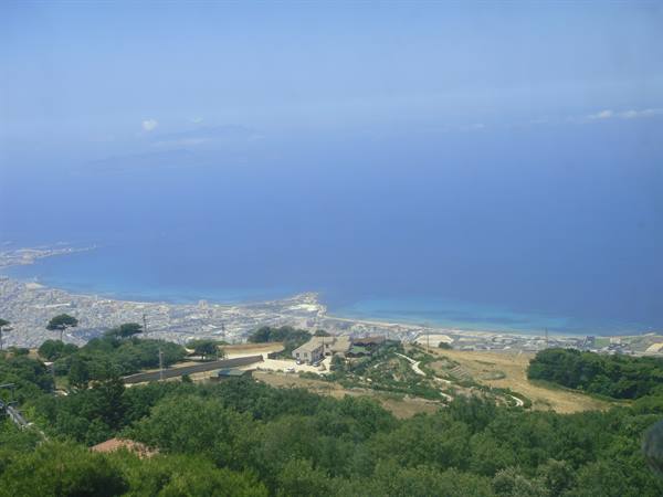 Palermo's coastline seen from the hillside, blue sea and houses among trees