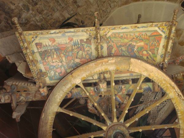 Sicilian wooden cart with painted panels and large spoked wheel