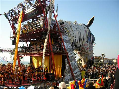 Carnival float with giant papier-mâché horse and costumed dancers