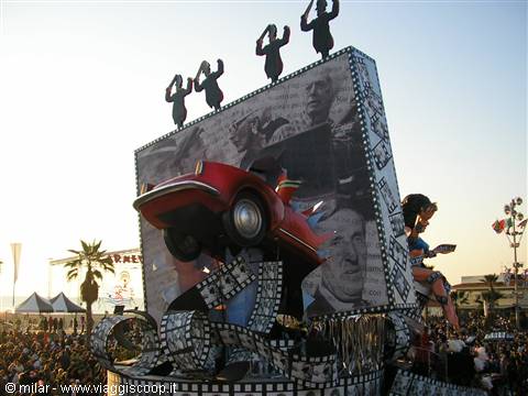 Viareggio carnival float with a red car and giant film reels