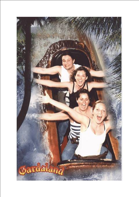 Four riders screaming with joy on the log flume splash ride at Gardaland