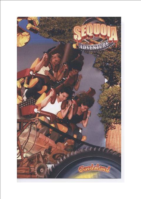 Riders scream on Sequoia Adventure at Gardaland, strapped in the coaster seats