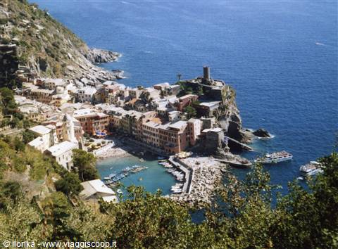 Vernazza, colorful village on the rock with pier, boats and castle by the sea