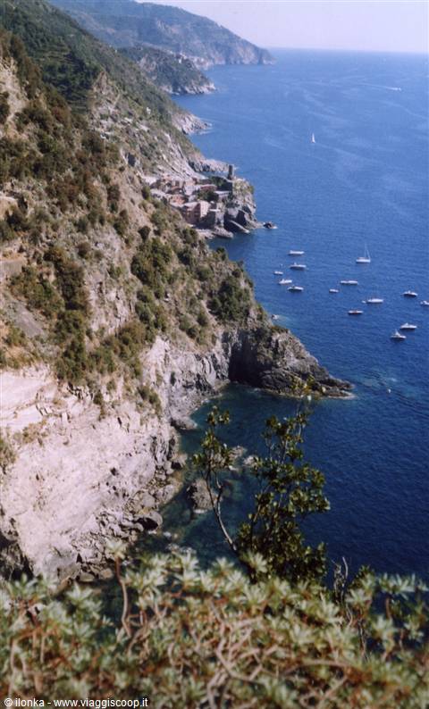 Vernazza on the Cinque Terre cliffs, boats anchored in the blue sea