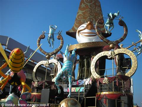 Viareggio Carnival float with giant smiling face and acrobats