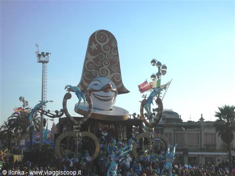 Giant carnival float with flying figures and smiling mask in Viareggio