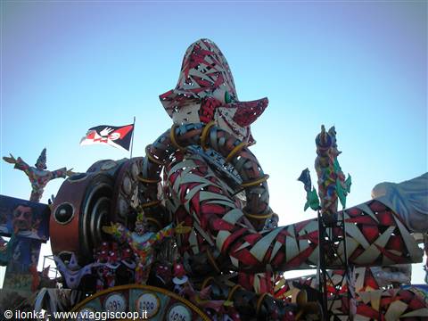 Carnival float in red and white papier-mâché against blue sky