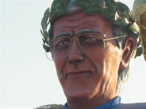 Carnival giant papier-mâché figure wearing laurel wreath and glasses