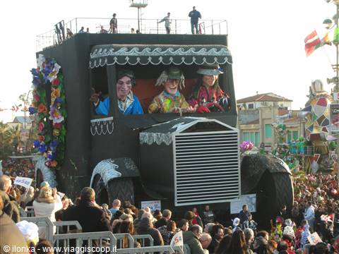 Carnival float in Viareggio, masked figures waving to the crowd