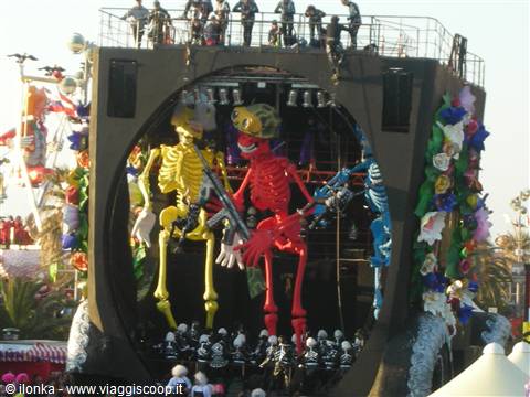 Viareggio Carnival: float with colorful giant skeletons and masked performers