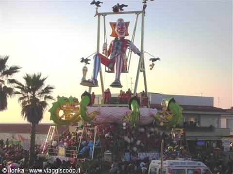 Viareggio Carnival: giant clown float towering over the evening crowd