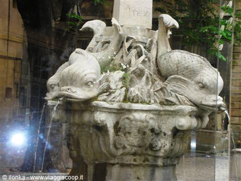 Marble fountain with dolphins spouting water