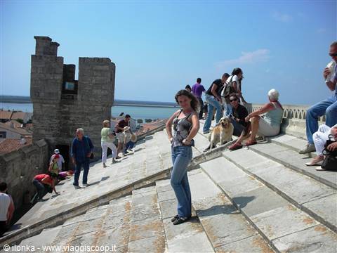 Tourists on the stone roof of Ancona cathedral, a woman poses in front