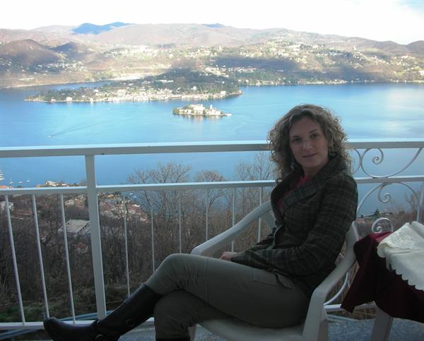 me on the terrace of the hotel room with the island in the background